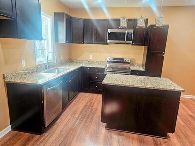Kitchen with a kitchen island, light stone counter
