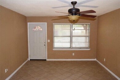 different view of living room with ceiling fan