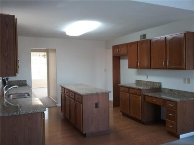 Updated kitchen with granite and stainless, and an abundance of cabinets.  Kitchen leads to the large pantry and formal Dining Room