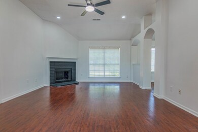 Unfurnished living room featuring a brick fireplac