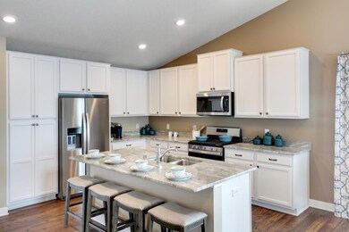 This home's kitchen is extremely functional and beautiful. Model photo, colors and selections may vary.