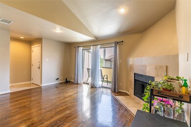 Living room featuring wood finished floors, a fireplace, recessed lighting, vaulted ceiling, and a textured​​‌​​​​‌​​‌‌​​‌​​​‌‌​​​​​​‌‌‌​​‌​​‌‌​​​‌ ceiling