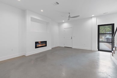 Unfurnished living room with visible vents, reces