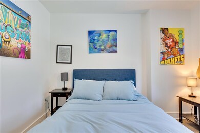 Bedroom with baseboards and wood finished floors