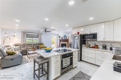 Kitchen featuring white cabinets, open floor plan,