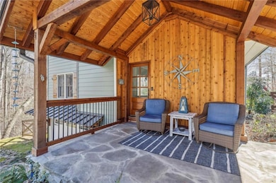 Sitting room with vaulted ceiling with beams, wood