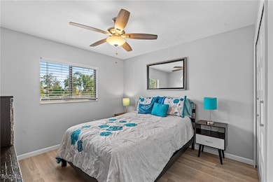 Bedroom with wood finished floors and ceiling fan