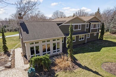 Stunning Hearth Room addition surrounded by floor to ceiling windows!