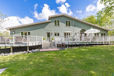 Rear view of property featuring a yard and a deck