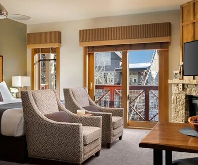 Living room featuring ceiling fan, carpet, and a f