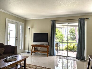 Living area featuring a textured ceiling, light ti