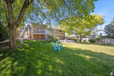 Fenced backyard with stairs and a deck