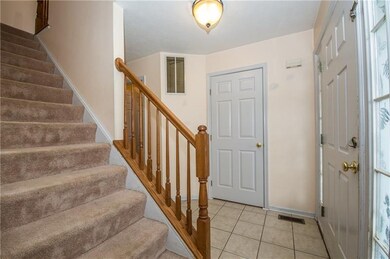 Large entry with ceramic floors, neutral colors.
