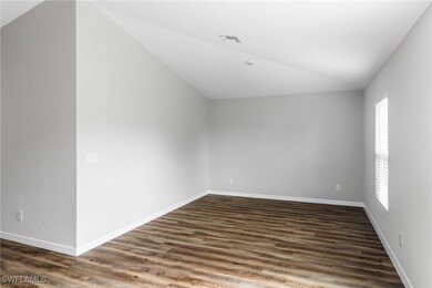 Additional living space featuring vaulted ceiling,