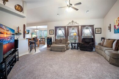 Living room opens to dining room and kitchen.