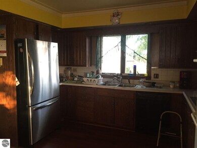 Kitchen includes stainless steel refrigerator