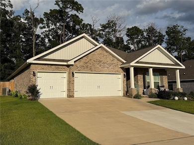 Craftsman-style home featuring board and batten siding, brick siding, and concrete driveway