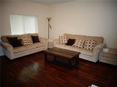LARGE LIVING ROOM AREA WITH LARGE WINDOW.
