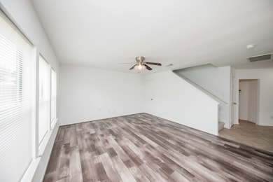 Large living room with ceiling fan.