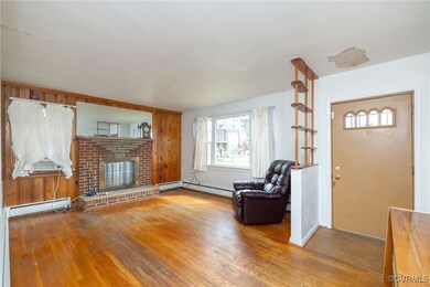 Living area with hardwood / wood-style floors, a f