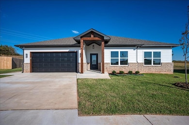 View of front of house with driveway, brick siding, an attached garage, and a shingled roof