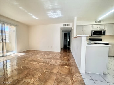 Kitchen featuring stainless steel microwave, range