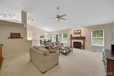 Vaulted ceiling, ceiling fan, and gas fireplace.