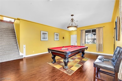 Playroom featuring dark wood-style flooring, billiards, and baseboards