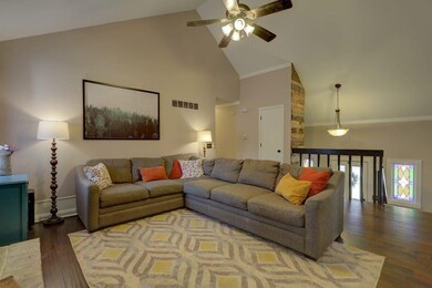 Main living area with vaulted ceiling and fireplac