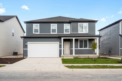 Traditional-style home featuring a porch, a shingled roof, driveway, and an attached garage