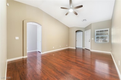 Unfurnished room featuring arched walkways, vaulte