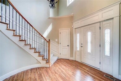 Dramatic Curved Staircase with Wrought Iron Spindl