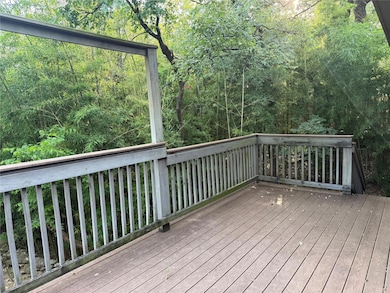 Wooden terrace featuring a view of trees