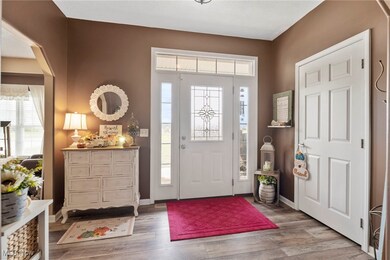 Entrance foyer with baseboards and wood finished floors