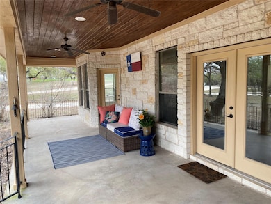View of patio / terrace with ceiling fan and fren