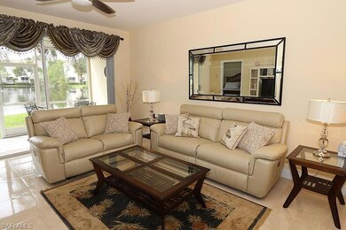 Living room featuring ceiling fan and light tile f