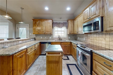 Kitchen with appliances with stainless steel finis