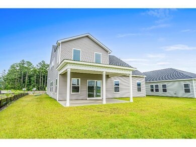 Rear view of property with a lawn and a patio