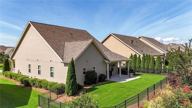 Rear view of house with roof with shingles, a patio area, and a fenced backyard
