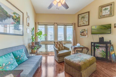 Sitting room featuring a ceiling fan and lofted ce