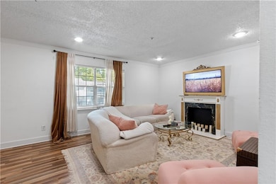 Living area featuring a textured ceiling, wood fin