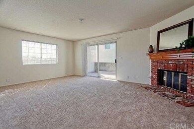 Formal living room with brick fireplace and private deck off through sliding glass doors. 