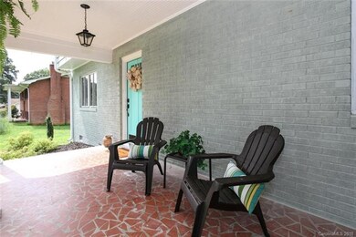 Covered front porch is shaded from the Carolina su