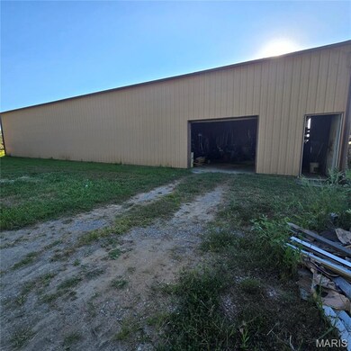 View of pole building featuring driveway