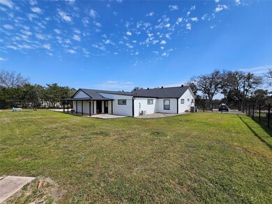 Back of property featuring a lawn, roof with shin