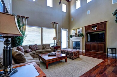 Living area featuring a towering ceiling, dark woo