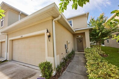 Walkway to the front door that opens to a bright view of the kitchen, dining room, living room, and screened in back patio / lanai.
