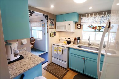 Bright and cheery kitchen finished off with granite countertops.
