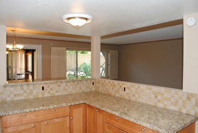 KITCHEN ISLAND OPENING TO LIVING/DINING