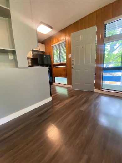 Kitchen featuring wooden walls, dark wood finishe